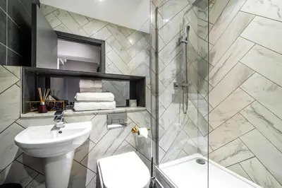 a bathroom with a sink and a toilet and a shower at Duke Street Townhouse by EPIC in Liverpool