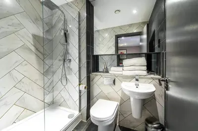 a bathroom with a toilet sink and a shower at Duke Street Townhouse by EPIC in Liverpool