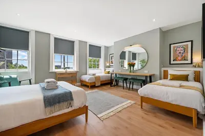 a bedroom with two beds and a desk at Host & Stay - Upper Duke Street Apartment in Liverpool