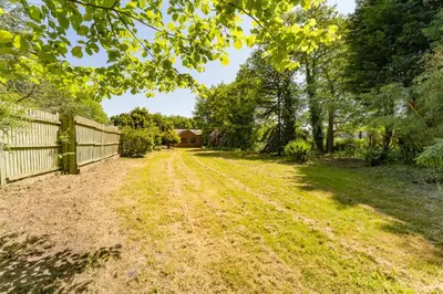 a dirt road in a yard with a fence and trees at Modern 5BR Victorian Home in Liverpool in Knowsley