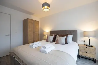 a bedroom with a large bed with towels on it at GuestReady - Amazing stay in Liverpool in Liverpool