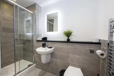 a bathroom with a toilet and a shower and a sink at GuestReady - Amazing stay in Liverpool in Liverpool