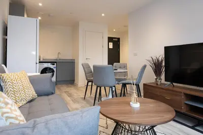 a living room with a couch and a tv and a table at GuestReady - Amazing stay in Liverpool in Liverpool