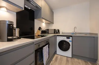 a kitchen with a washer and dryer in it at GuestReady - Amazing stay in Liverpool in Liverpool