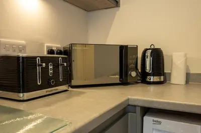 a microwave sitting on top of a kitchen counter at GuestReady - Amazing stay in Liverpool in Liverpool