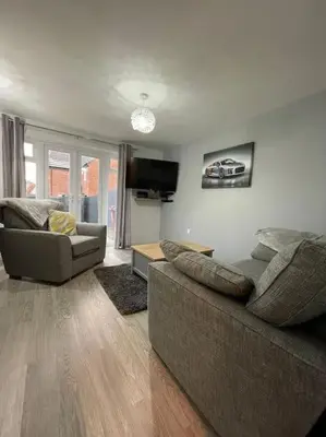 a living room with two couches and a tv at Tootle Drive in Longridge