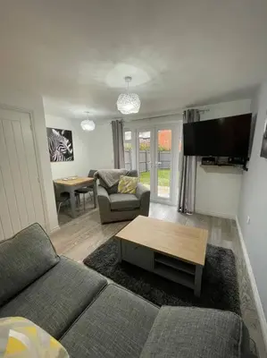 a living room with a couch and a table at Tootle Drive in Longridge