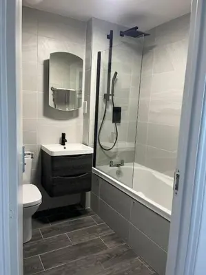 a bathroom with a shower and a sink and a toilet at Tootle Drive in Longridge