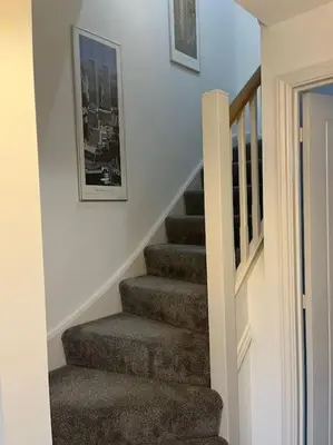 a staircase in a house with a picture on the wall at Tootle Drive in Longridge