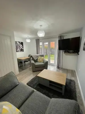 a living room with a couch and a table at Tootle Drive in Longridge