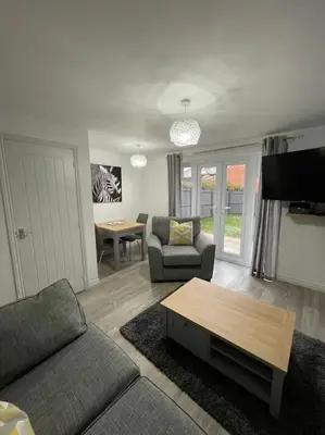 a living room with a couch and a table at Tootle Drive in Longridge