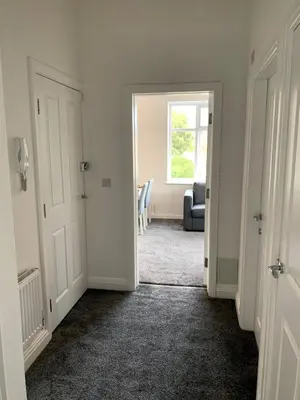 an empty room with a door and a window at New large 2 bedroom apartment with private parking in Lea Town