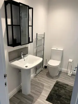 a bathroom with a sink and a toilet at New large 2 bedroom apartment with private parking in Lea Town