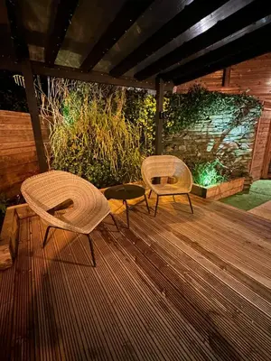 two chairs and a table on a wooden deck at The Cottage Hideout in Upholland