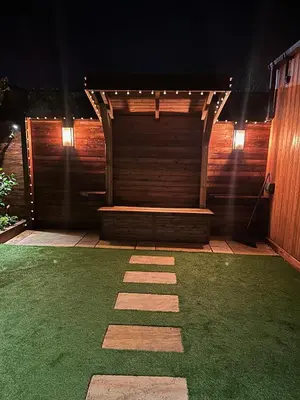 a wooden bench sitting on top of a grass field at The Cottage Hideout in Upholland