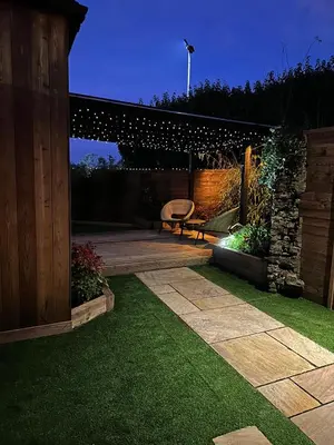 a patio with a bench and a table in a yard at The Cottage Hideout in Upholland
