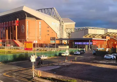a parking lot in front of a large building at Kop View in Liverpool