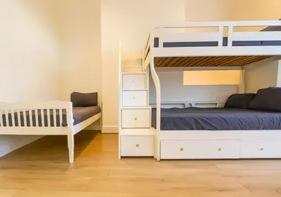 a bedroom with two bunk beds and a bed and a couch at Kop View in Liverpool