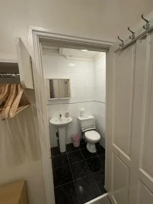 a small bathroom with a toilet and a sink at Valencia in Blackpool