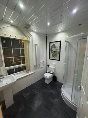 a bathroom with a toilet and a sink and a shower at Valencia in Blackpool