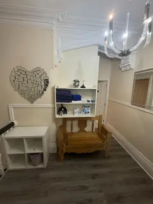 a room with a bench and a heart on the wall at Valencia in Blackpool