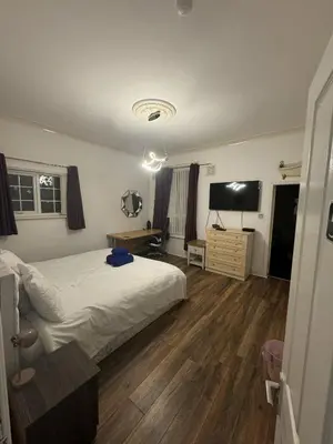 a bedroom with a bed and a flat screen tv at Valencia in Blackpool