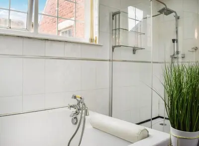 a bathroom with a shower and a bath tub at Valencia in Blackpool