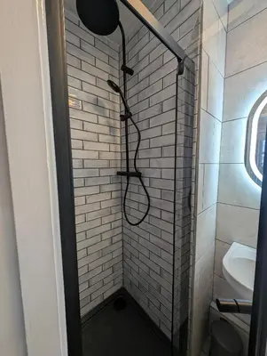 a small bathroom with a shower with a sink at Hesketh Hotel in Blackpool