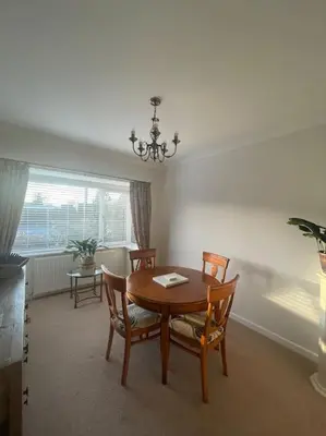 a dining room with a wooden table and chairs at Fylde Coast Stays - Home from Home in Freckleton