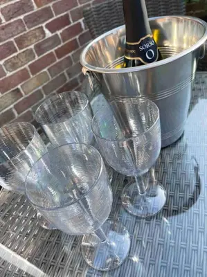 a group of wine glasses and a bucket on a table at Fylde Coast Stays - Home from Home in Freckleton