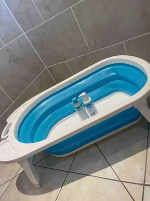 a bath tub with two water bottles in it at Fylde Coast Stays - Home from Home in Freckleton