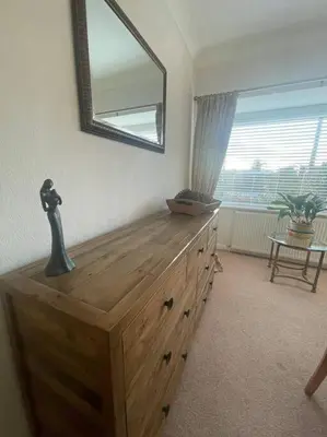 a wooden dresser in a room with a mirror at Fylde Coast Stays - Home from Home in Freckleton