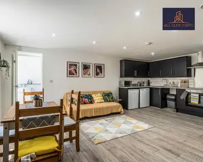 a living room with a bed and a kitchen at Swan House Apartment 9 - 2 Bed Apartment - Sleeps 6 - Free Parking - Liverpool - close to city centre - By ALL ELITE STAYS in Liverpool