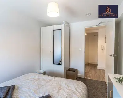 a white bedroom with a bed and a mirror at Swan House Apartment 9 - 2 Bed Apartment - Sleeps 6 - Free Parking - Liverpool - close to city centre - By ALL ELITE STAYS in Liverpool