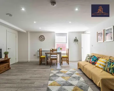 a living room with a couch and a table at Swan House Apartment 9 - 2 Bed Apartment - Sleeps 6 - Free Parking - Liverpool - close to city centre - By ALL ELITE STAYS in Liverpool