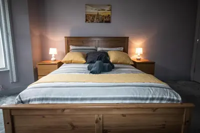 a bedroom with a large bed with two lamps at Blackpool Townhouse in Blackpool