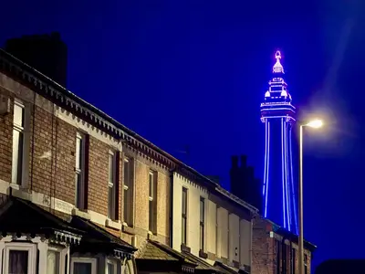 a lighthouse lit up in blue at night at Blackpool Townhouse in Blackpool