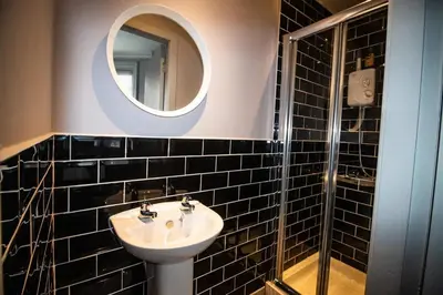 a bathroom with a sink and a mirror at Blackpool Townhouse in Blackpool