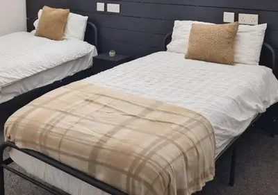 a bedroom with two beds with pillows on them at Matchday Mile House Walk to Anfield sleeps 8 in Liverpool