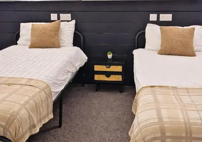 two beds sitting next to each other in a room at Matchday Mile House Walk to Anfield sleeps 8 in Liverpool
