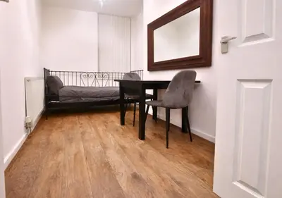 a dining room with a table and a chair at Matchday Mile House Walk to Anfield sleeps 8 in Liverpool