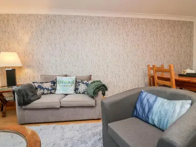 a living room with a couch and a chair at Time and Tide in Carnforth