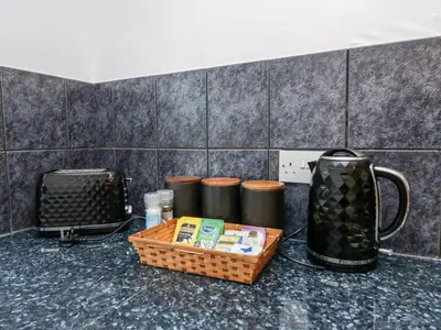 a table with a basket and a jug on a counter at Time and Tide in Carnforth