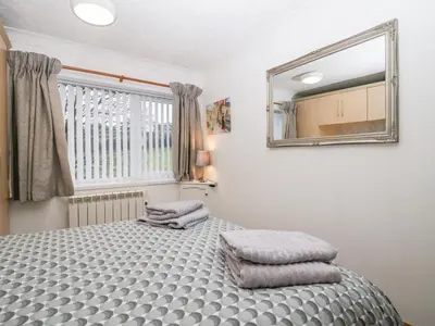 a bedroom with a bed with two pillows on it at Time and Tide in Carnforth