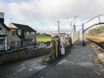 a train station with a sign that says way out at Time and Tide in Carnforth