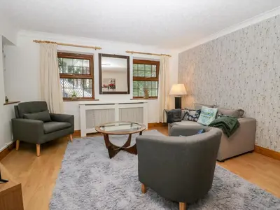 a living room with a couch and two chairs and a table at Time and Tide in Carnforth