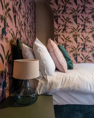 a bed with pillows and a lamp on a table at Entire Modern House Liverpool, 6 Bedrooms in Liverpool