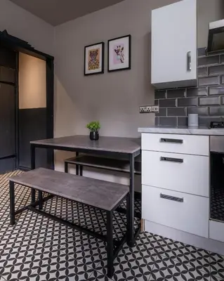 a kitchen with a table and a bench in a room at Entire Modern House Liverpool, 6 Bedrooms in Liverpool