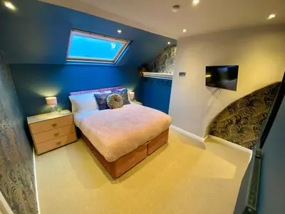 a small bedroom with a bed and a window at Entire Modern House Liverpool, 6 Bedrooms in Liverpool