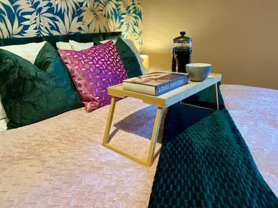 a table with a book and a bottle on a bed at Entire Modern House Liverpool, 6 Bedrooms in Liverpool